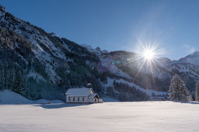 Sunny winter landscape with deep snow nature and bright sun in the sky