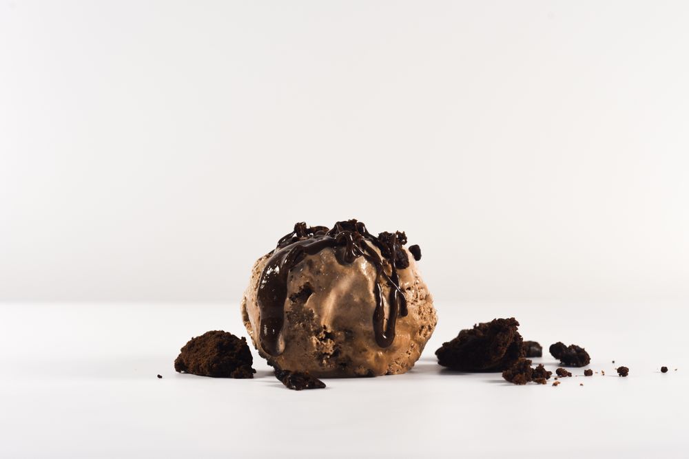 Scoop of chocolate ice cream with brownie pieces