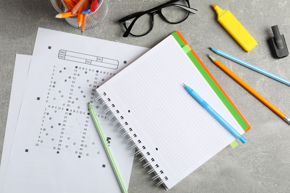 Top view of multiple choice test and notebook