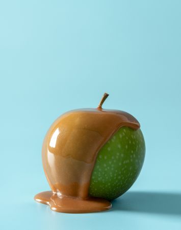Caramel apple isolated on a blue background