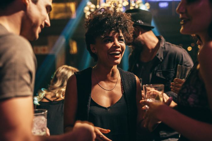 Shot of young woman enjoying nightclub with friends