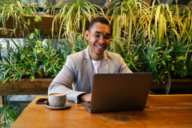 Man working on laptop at cafeteria
