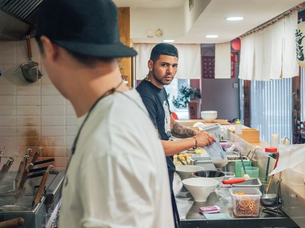 Multiethnic cooks working in kitchen of cafe