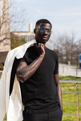 Stylish Black businessman in eyeglasses in town