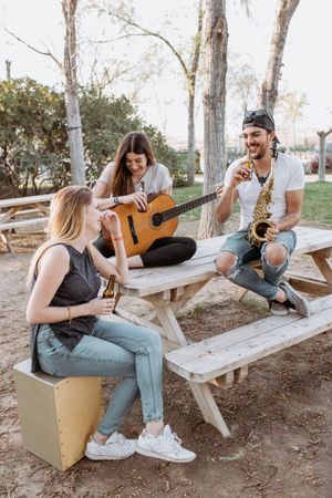 Young musicians drinking beer in park