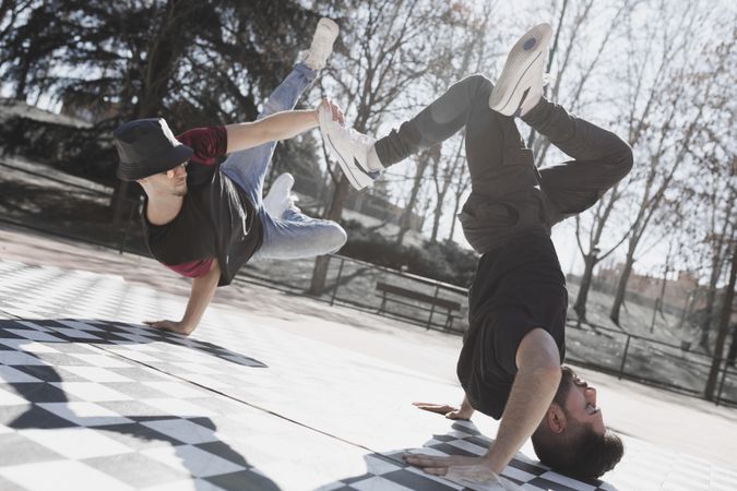 Young men dancing break dance in park