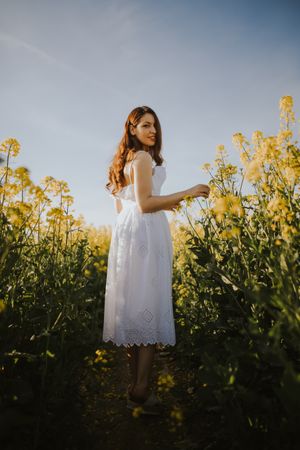Woman with flowers in field