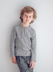 Charming boy standing near wall