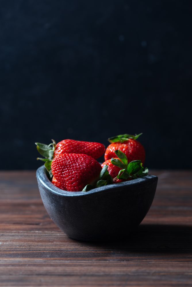 Fresh ripe strawberries in concrete bowl