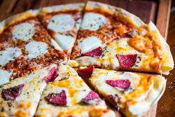 Freshly baked half and half Italian pizza on board