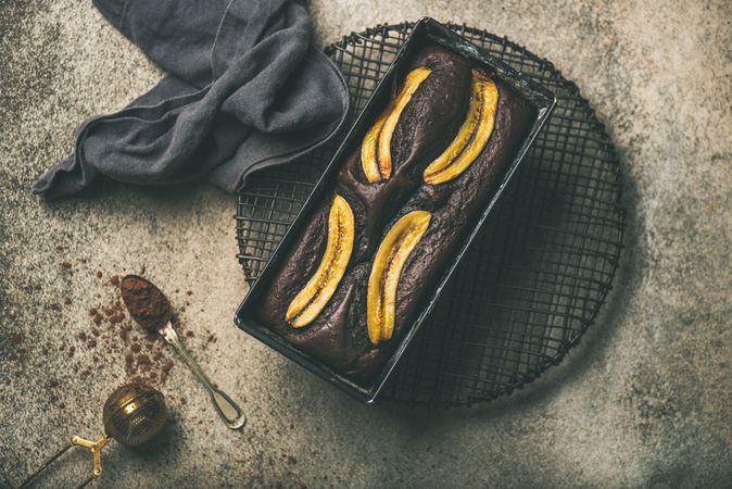 Freshly baked dark chocolate banana bread cake on concrete counter
