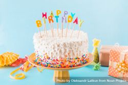 Birthday cake with gift accessories blue background 0PYdr5