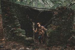 Unrecognizable hiker in green forest