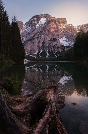 Houseboat surrounded with mountains on serene lake