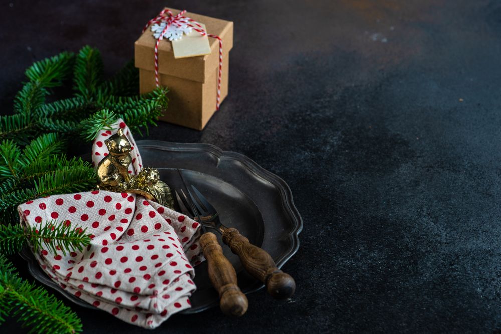 Dark plate with dotted napkin on Christmas table setting
