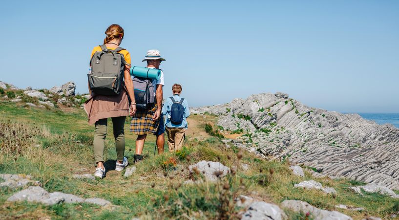Group of people with hiking equipment walking outside