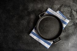 Empty pan on striped napkin as a table setting concept with space for text