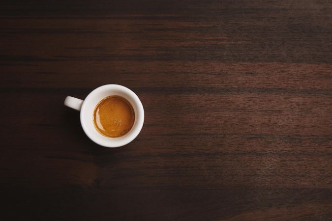Top view of espresso shot on wooden table