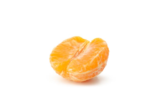 Half of ripe mandarin isolated on light background