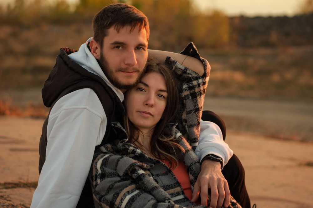 Couple sitting dusk countryside