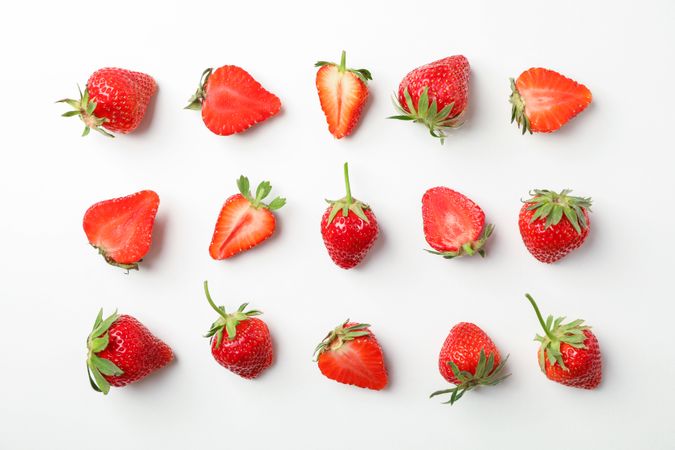 Flat lay composition with strawberries on light background, space for text. Summer sweet fruits and berries