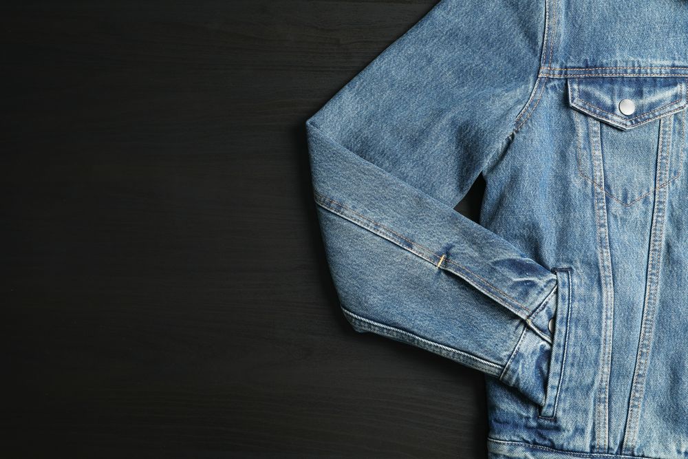 Denim jacket on background, space for text