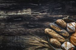 Assorted gold homemade bread on dark wood background