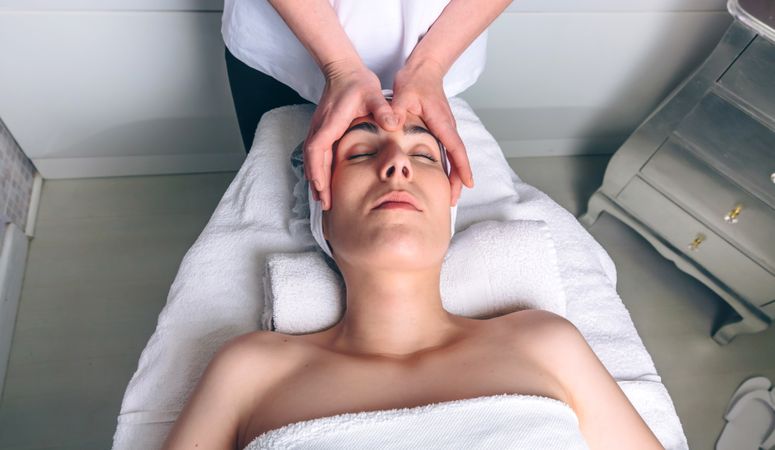 Female client receiving a relaxing facial massage