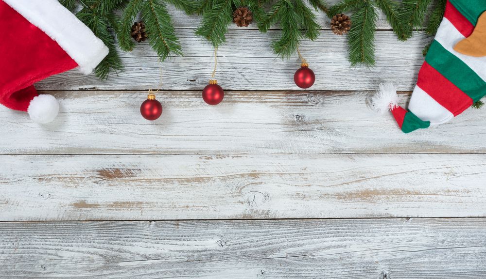 Top border of Christmas decorations on rustic wooden background