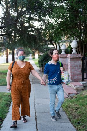 Full length shot of partners returning from grocery store with groceries