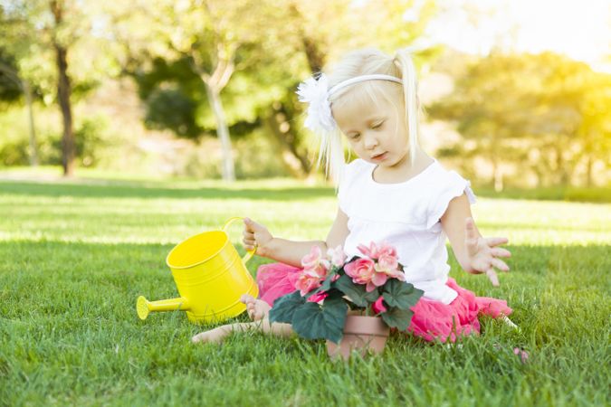 Cute Little Girl Playing Gardener with Her Tools and Flower Pot.