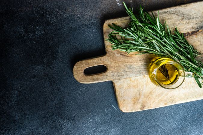 Top view of olive oil and fresh rosemary