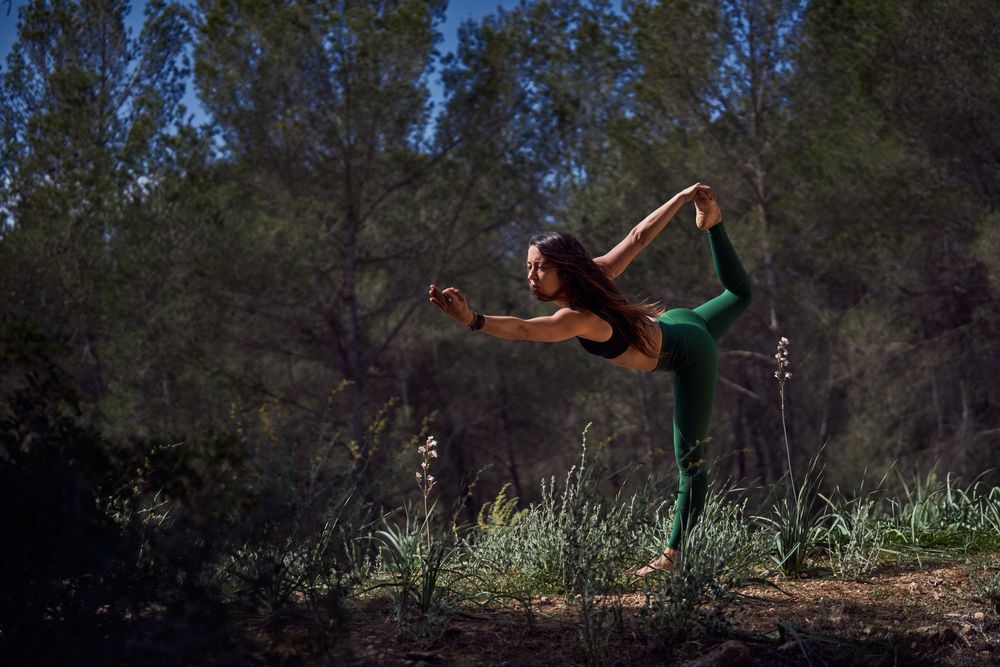 Hispanic doing Standing bow in nature