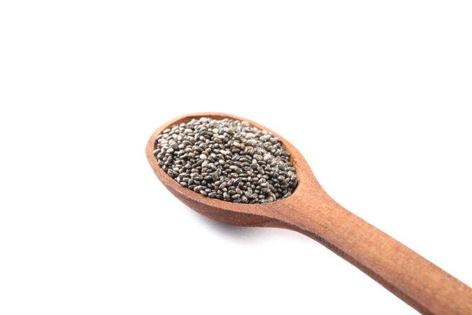 Chia seeds and wooden spoon isolated on plain background