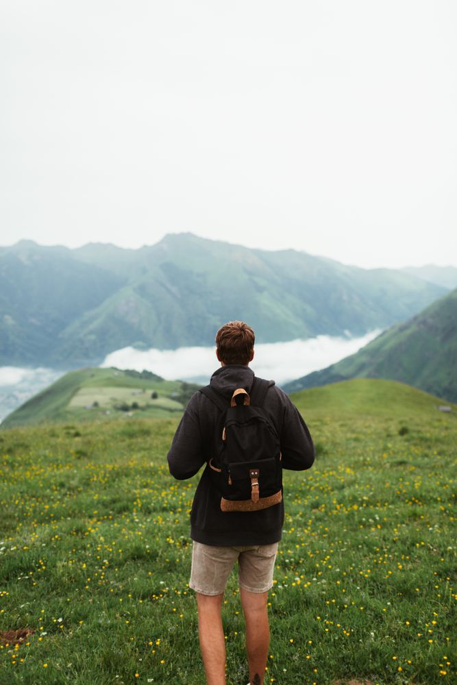 Anonymous male admiring view of mountain ridge
