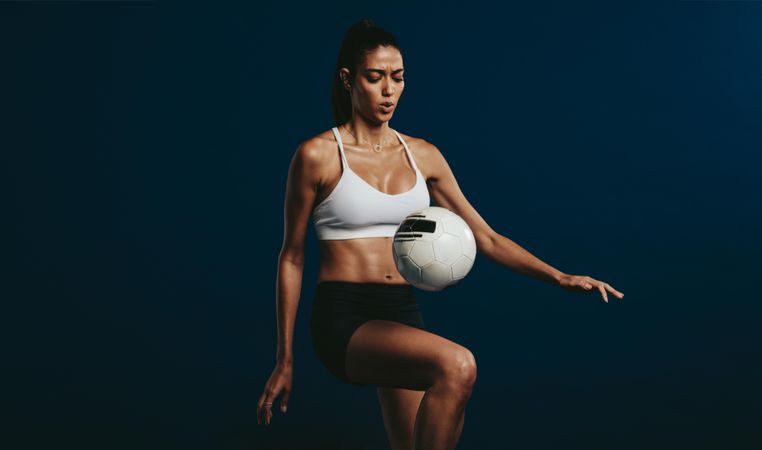 Woman soccer player concentrating on juggling techniques