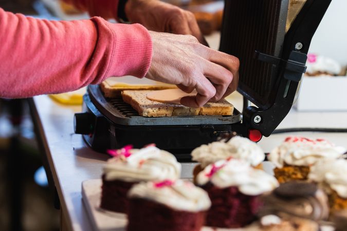 Crop cook preparing vegan sandwiches in kitchen