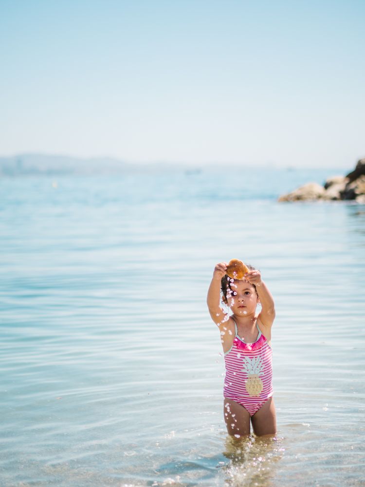 Cute girl playing in water of seaside