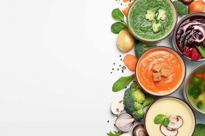 Colorful soups arranged on right of picture with copy space