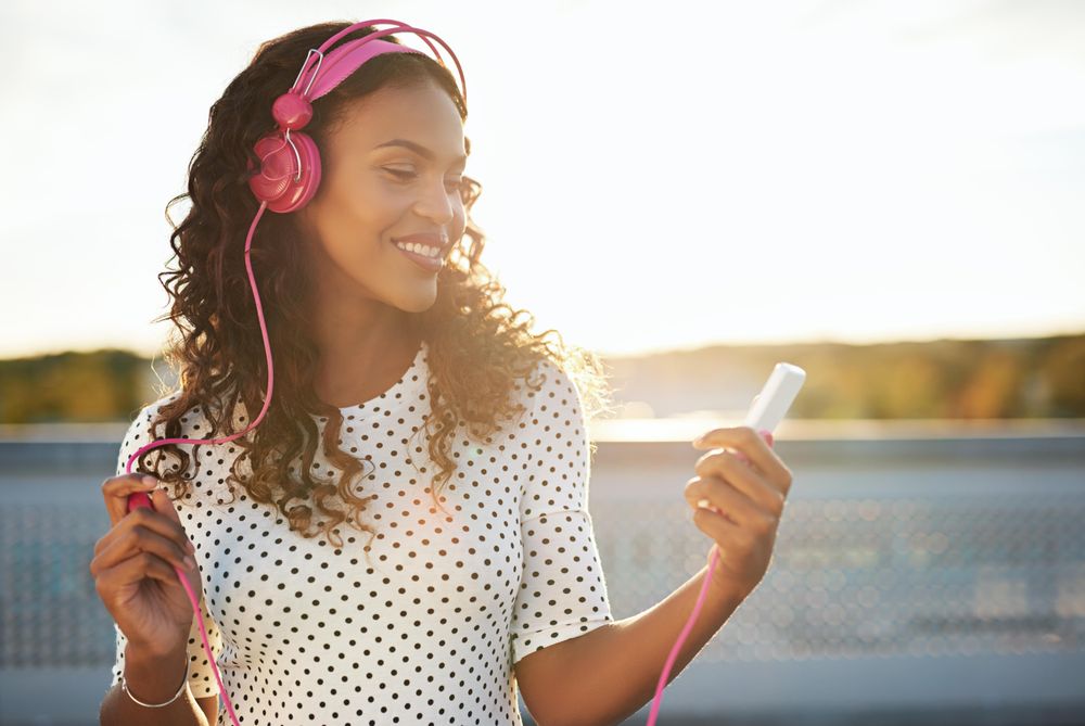 Woman smiling while listening to music on her phone