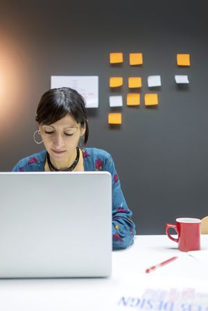 Smiling businesswoman working with laptop