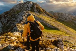 mountaineer hiking on a mountain peak
