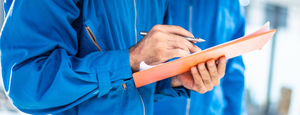 Banner of male mechanic writing on clipboard
