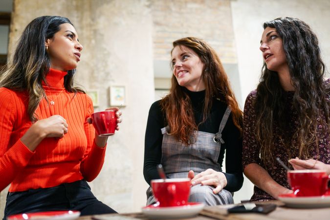 Three women enjoying coffee at cafe