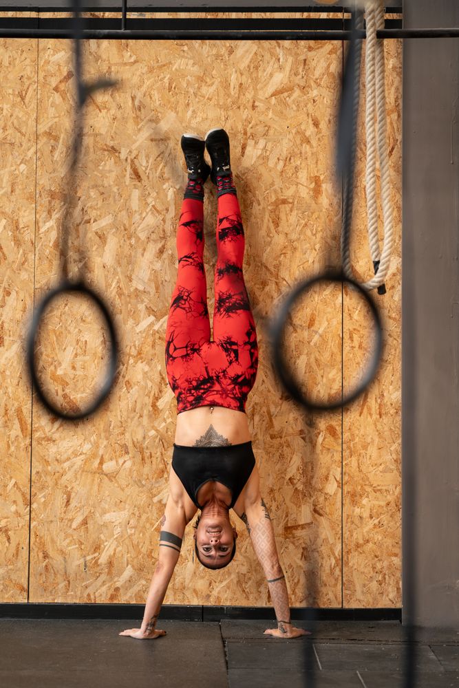 Woman performing handstand exercise in the gym