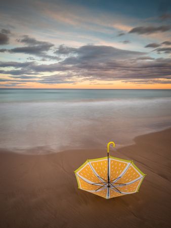 Umbrella on beach near sea