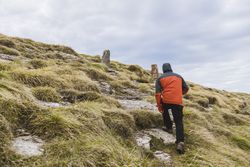 Man walking on hill near valley