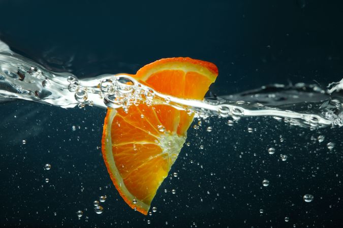 Side view of water on dark background with orange