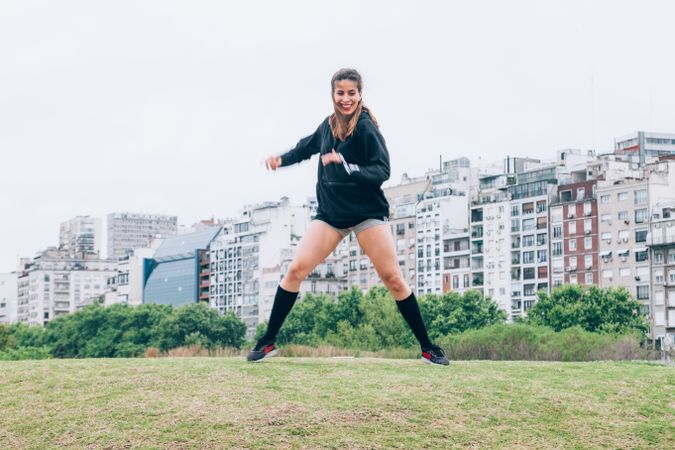 Sportswoman practicing yoga on lawn