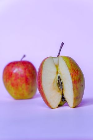 A split apple with a pink background, a perfect photo for a food flogger